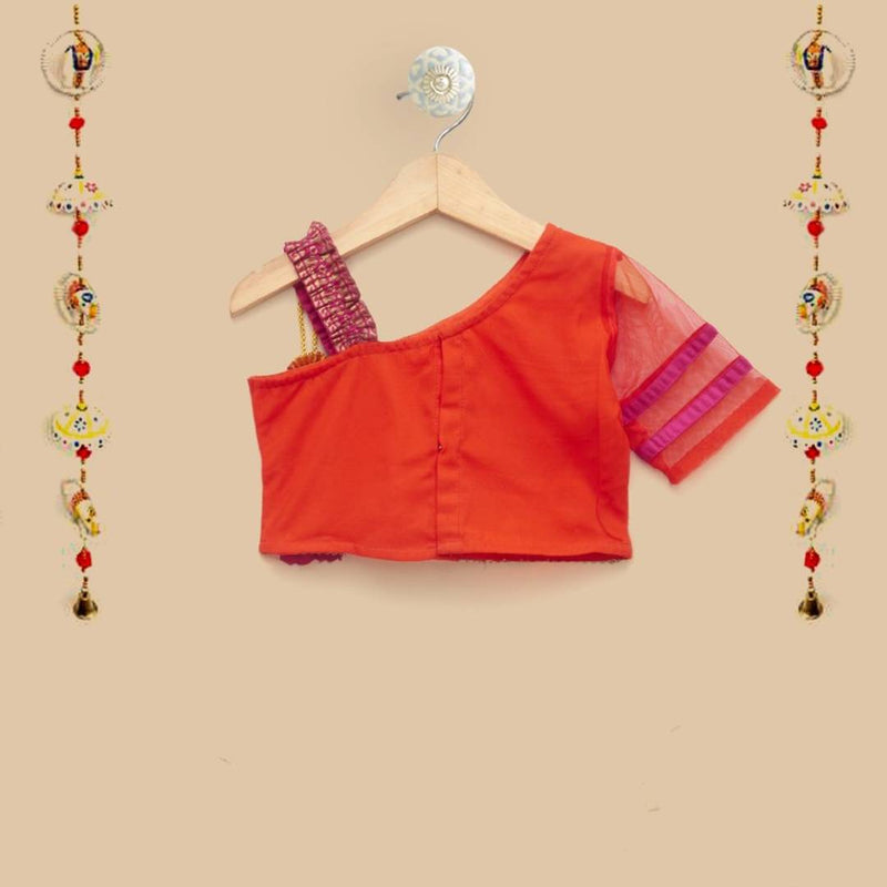 The Magic Wand Baby Girls Ethnic Wear One Shoulder Embellished Net Crop Top With Gold Foil Printed Dhoti Set in Orange and Fuchsia Color